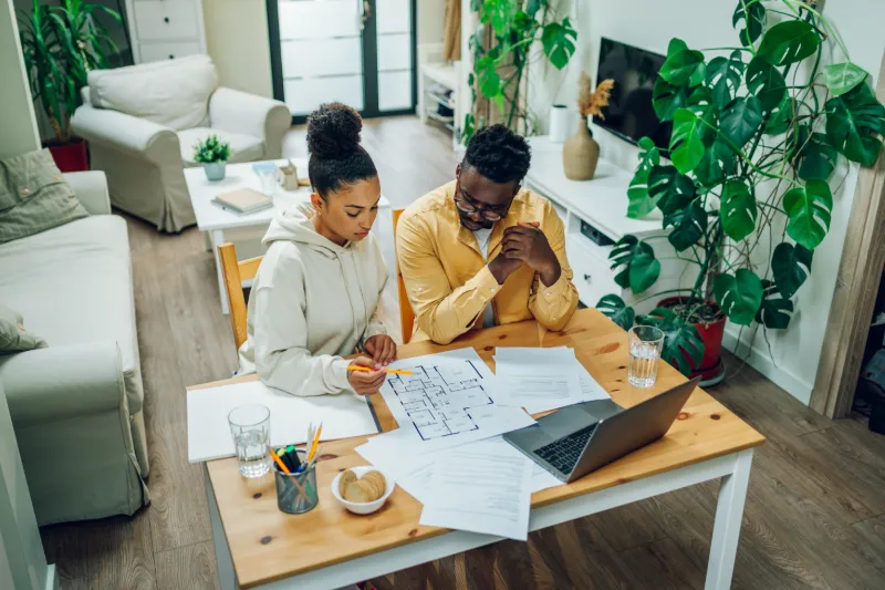 Couple looking over construction plans